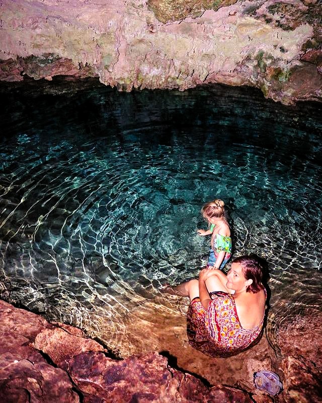Kuza Cave natural limestone cave with crystal clear blue water in Zanzibar